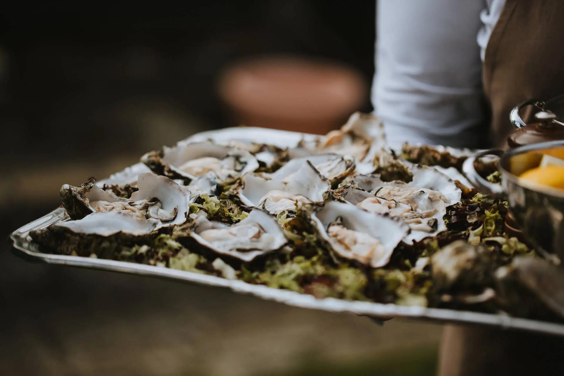 Schaal met verse oesters wordt rondgedragen